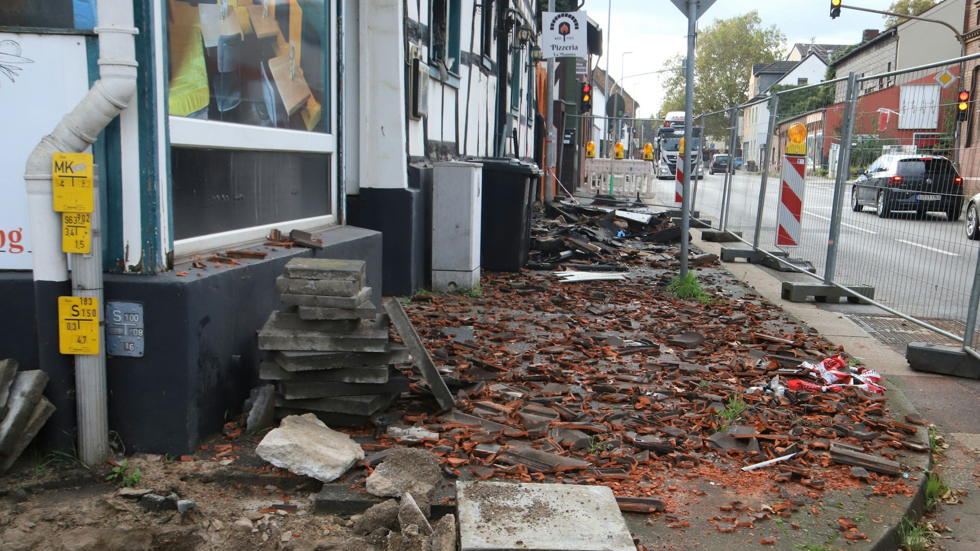 An der Siegstraße in Sankt Augustin-Menden liegt der Brandschutt noch auf dem Bürgersteig.