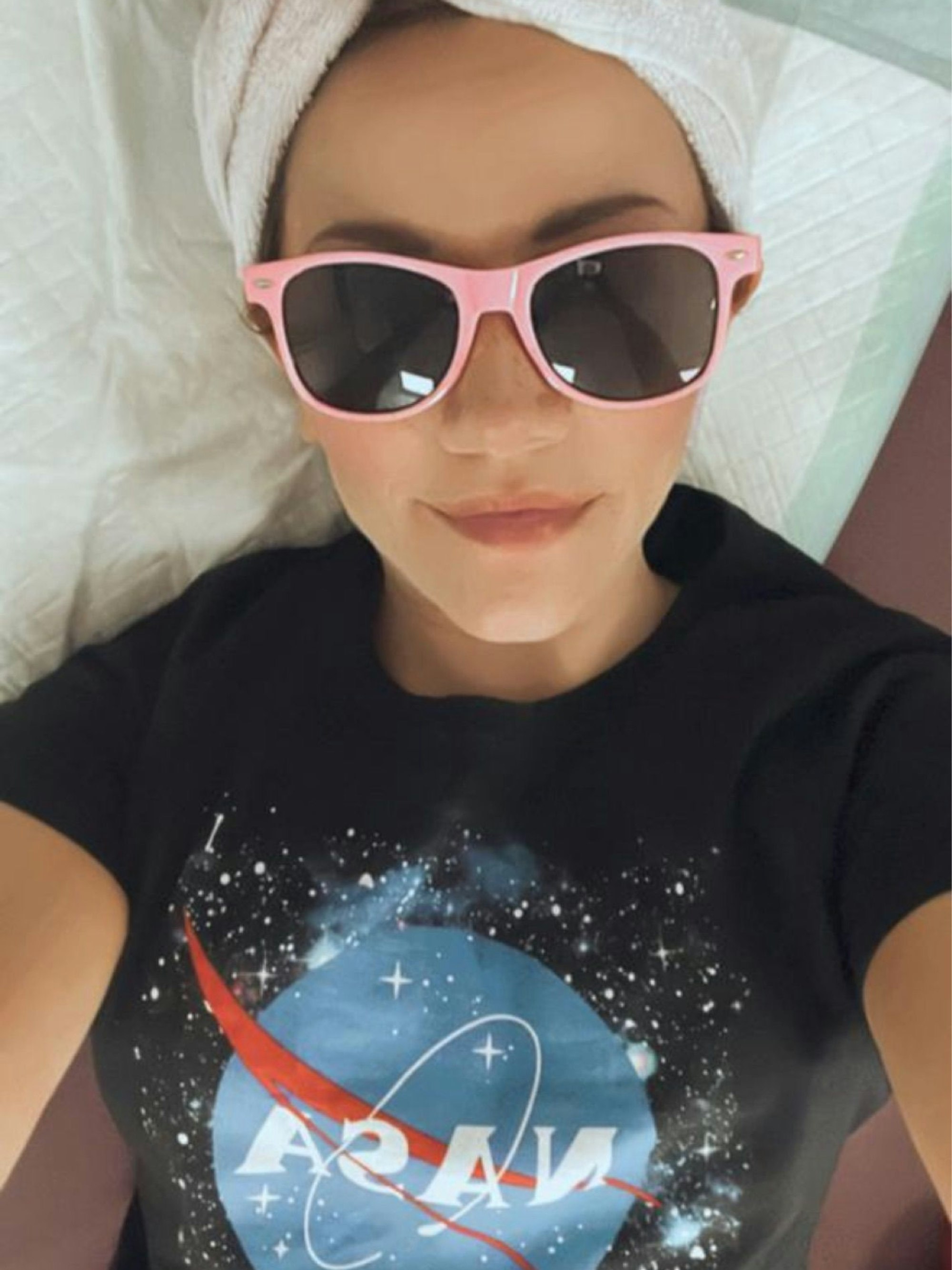 Probandin Angelina liegt mit Sonnenbrille und im Nasa-Tshirt während der Stuide im Bett und hat ein Selfie gemacht.