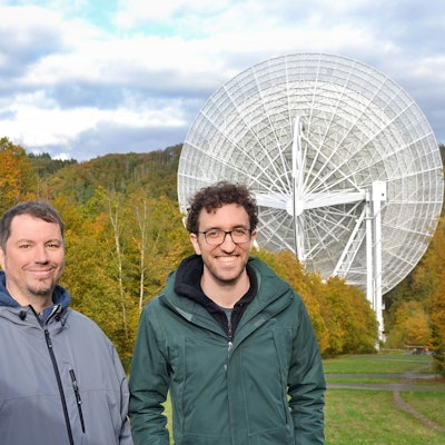 Die Forscher Benjamin Winkel und Marlon Bause (v.l.) stehen vor dem Radioteleskop in Effelsberg.