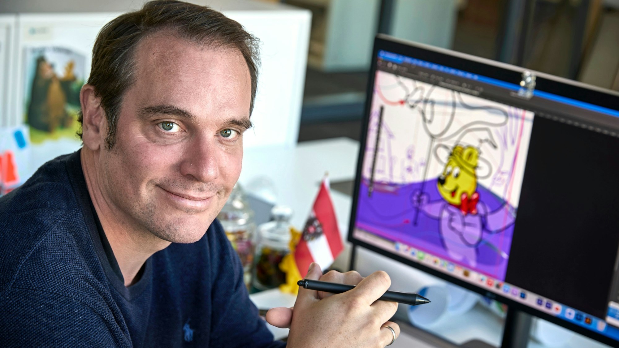 Konrad Lohrmann, Zeichner des Haribo-Goldbären an seinem Schreibtisch vor einem Mac