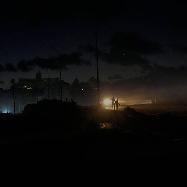 Residents walk on a street during a blackout following the failure of a major power plant in Havana, Cuba, Sunday, Oct. 20, 2024. (AP Photo/Ramon Espinosa)