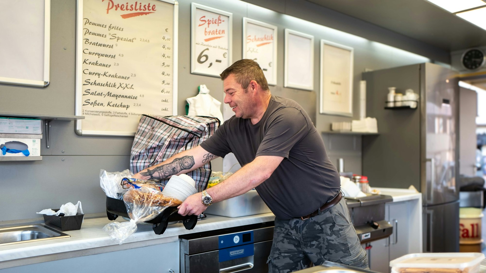 Günther Hündgen steht in seinem Imbisswagen und bereitet alles für den Start der Kirmes in Euskirchen vor.