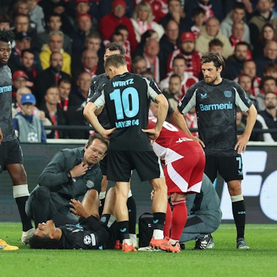 Bayer Leverkusen's Moroccan forward #21 Amine Adli (C) receives medical attention as he lies injured on the ground during the UEFA Champions League 1st round day 3 football match between Brest (FRA) and Bayer Leverkusen (GER) at the Stade de Roudourou in Guingamp, northern France, on October 23, 2024. (Photo by FRED TANNEAU / AFP)