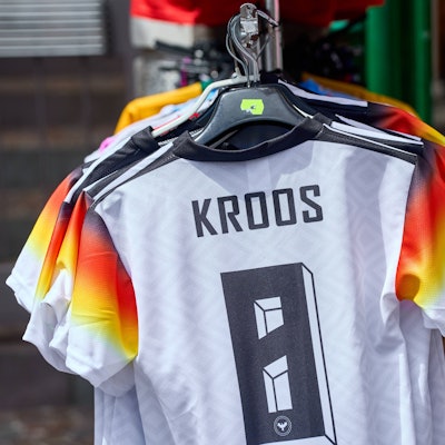 Auf einem Straßenmarkt werden gefälschte Deutschland Trikots günstig angeboten.