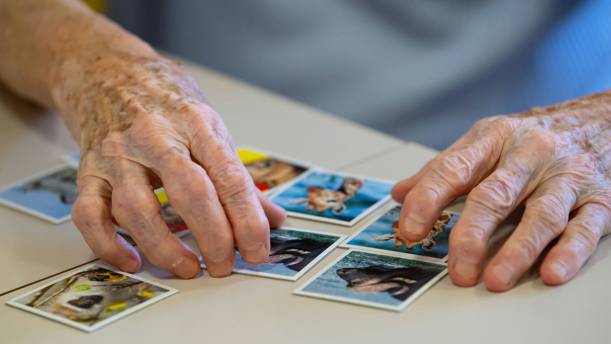 Eine Bewohnerin eines Altenheims spielt auf einer Pflegestation das Spiel „Memory“und legt Kartenpaare zusammen.