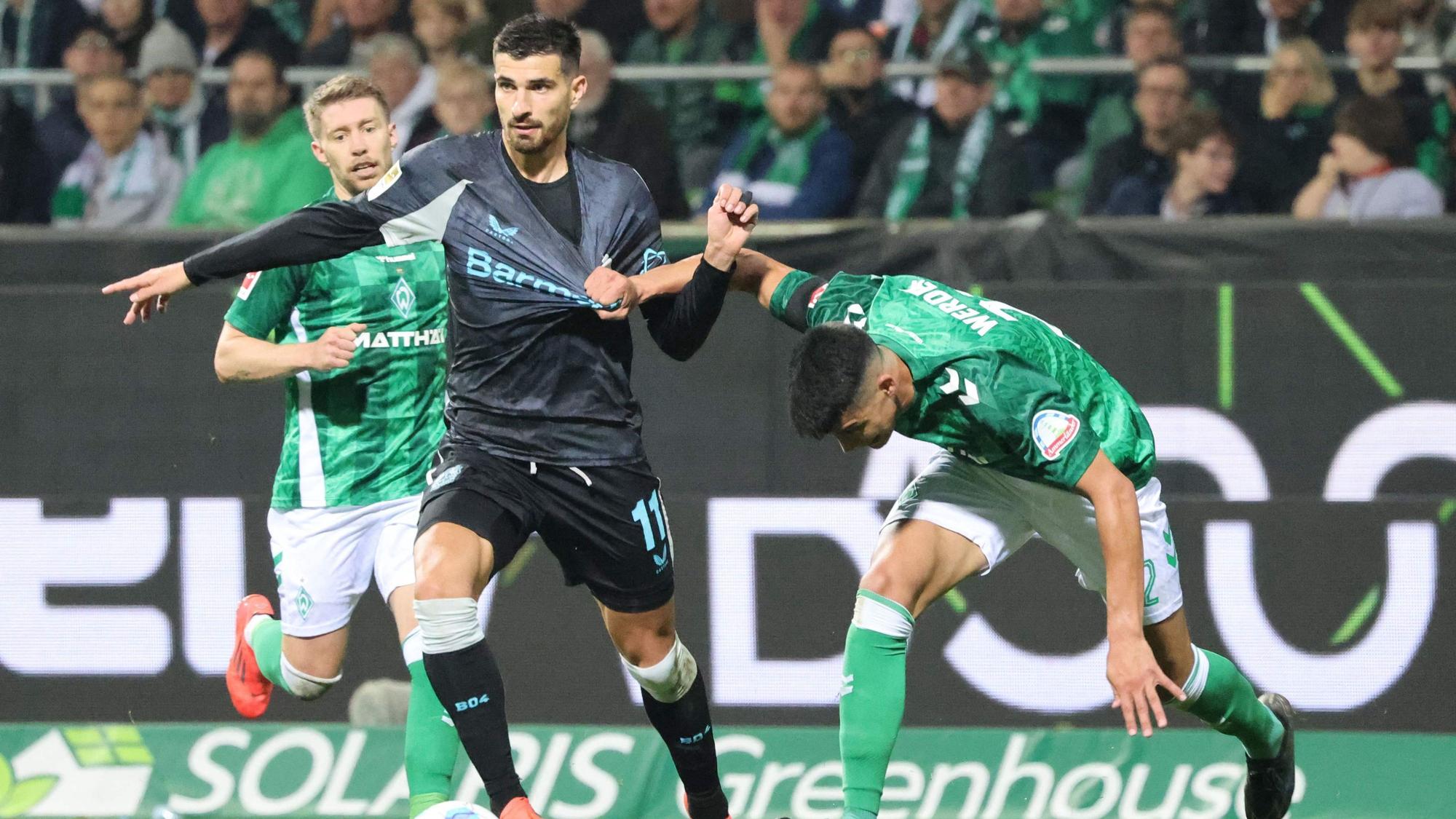 Bayer Leverkusen's French forward #11 Martin Terrier and Bremen's Argentinia defender #22 Julian Malatini vie for the ball during the German first division Bundesliga football match between SV Werder Bremen and Bayer Leverkusen in Bremen, northern Germany on October 26, 2024. (Photo by Focke Strangmann / AFP) / DFL REGULATIONS PROHIBIT ANY USE OF PHOTOGRAPHS AS IMAGE SEQUENCES AND/OR QUASI-VIDEO