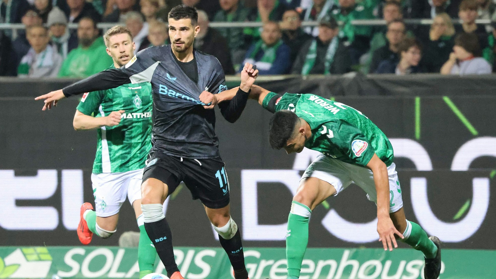 Bayer Leverkusen's French forward #11 Martin Terrier and Bremen's Argentinia defender #22 Julian Malatini vie for the ball during the German first division Bundesliga football match between SV Werder Bremen and Bayer Leverkusen in Bremen, northern Germany on October 26, 2024. (Photo by Focke Strangmann / AFP) / DFL REGULATIONS PROHIBIT ANY USE OF PHOTOGRAPHS AS IMAGE SEQUENCES AND/OR QUASI-VIDEO