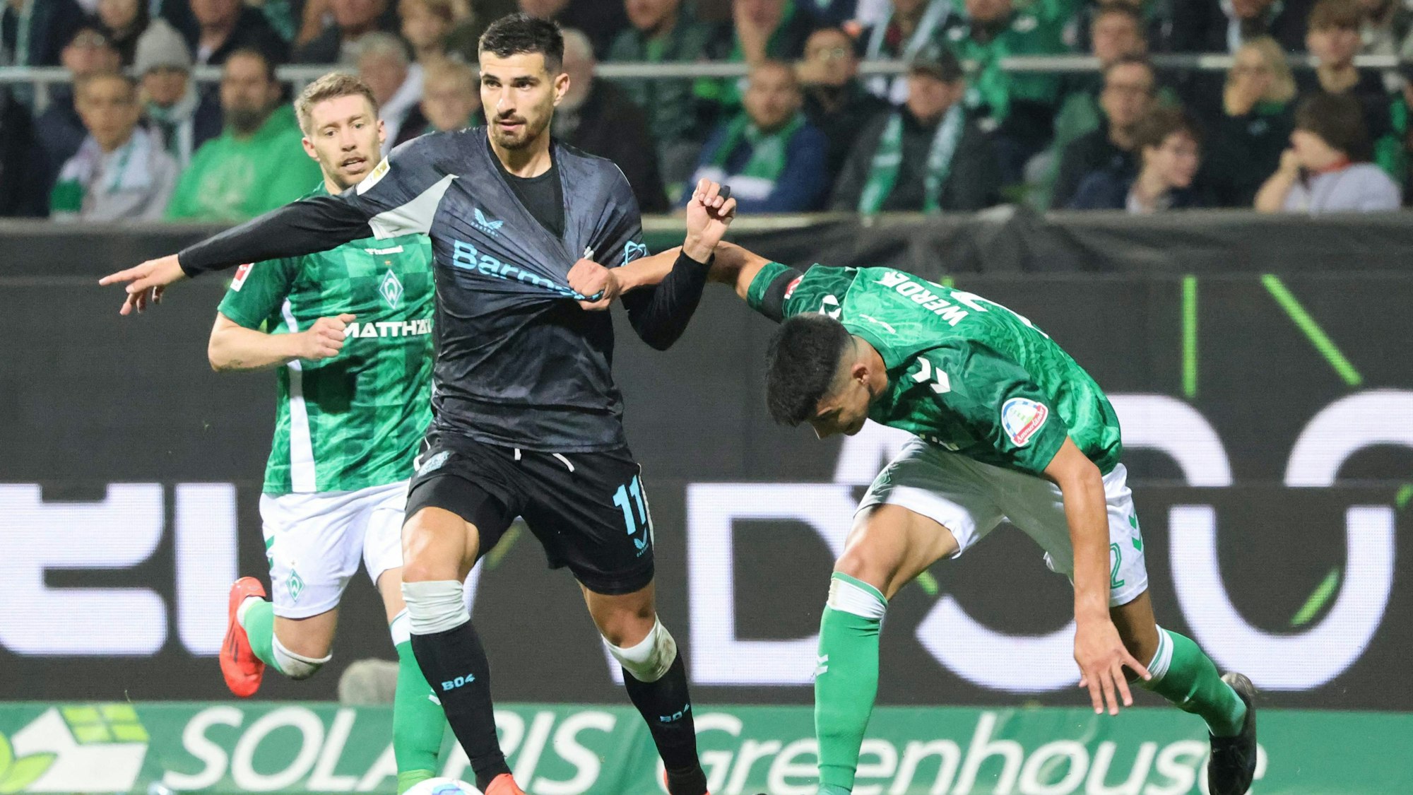 Bayer Leverkusen's French forward #11 Martin Terrier and Bremen's Argentinia defender #22 Julian Malatini vie for the ball during the German first division Bundesliga football match between SV Werder Bremen and Bayer Leverkusen in Bremen, northern Germany on October 26, 2024. (Photo by Focke Strangmann / AFP) / DFL REGULATIONS PROHIBIT ANY USE OF PHOTOGRAPHS AS IMAGE SEQUENCES AND/OR QUASI-VIDEO