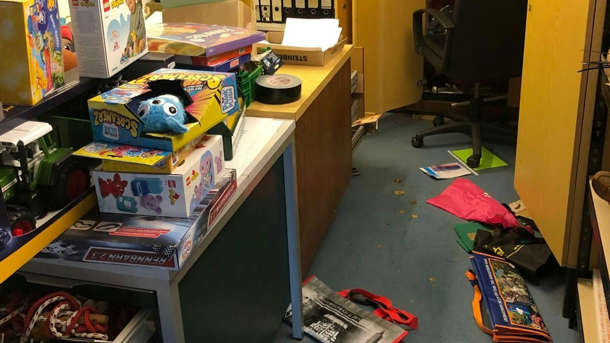 In einem Raum liegen Sachen nach einem Einbruch auf dem Boden.