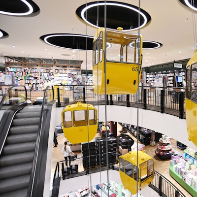 Gondeln, die an die Rheinseilbahn erinnern, schweben nun im Treppenhaus der Thalia Mayerschen.