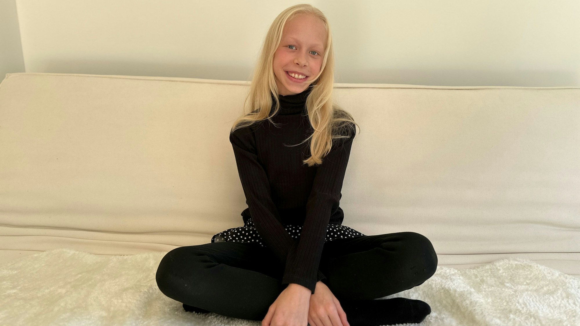 Die zwölfjährige Gymnasiastin Maja Mainka aus Köln-Weiß sitzt auf ihrem Bett.