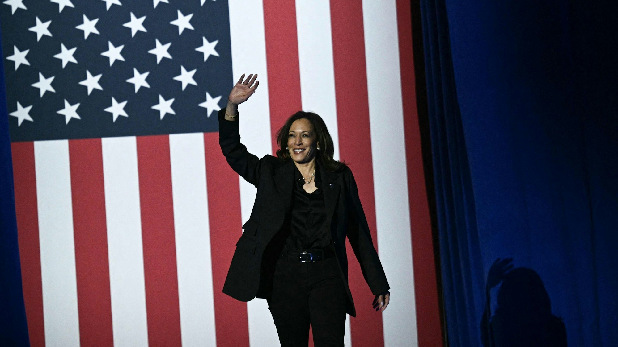 TOPSHOT - US Vice President and Democratic presidential candidate Kamala Harris waves as she arrives to speak during a "When We Vote We Win" rally at the Wisconsin State Fair Park Exposition Center in West Allis, Milwaukee, Wisconsin, November 1, 2024. (Photo by Brendan SMIALOWSKI / AFP)