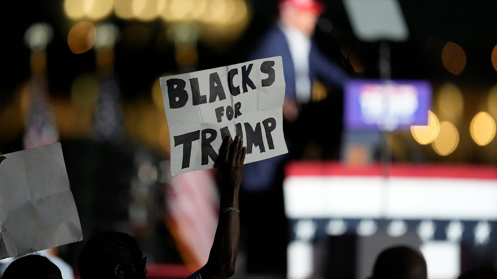 FILE - A supporter holds up a sign as Republican presidential candidate former President Donald Trump speaks at a campaign rally at Trump National Doral Miami, July 9, 2024, in Doral, Fla. (AP Photo/Rebecca Blackwell, File)