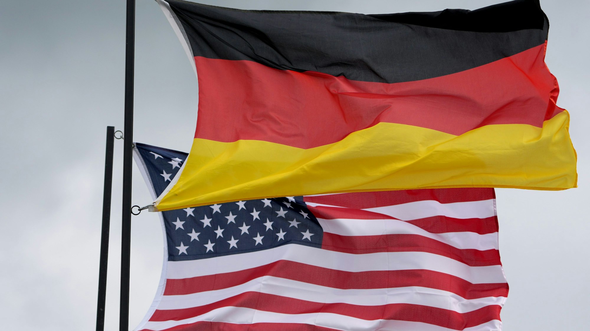 Die Nationalflaggen von Deutschland und den Vereinigten Staaten von Amerika wehen im Wind