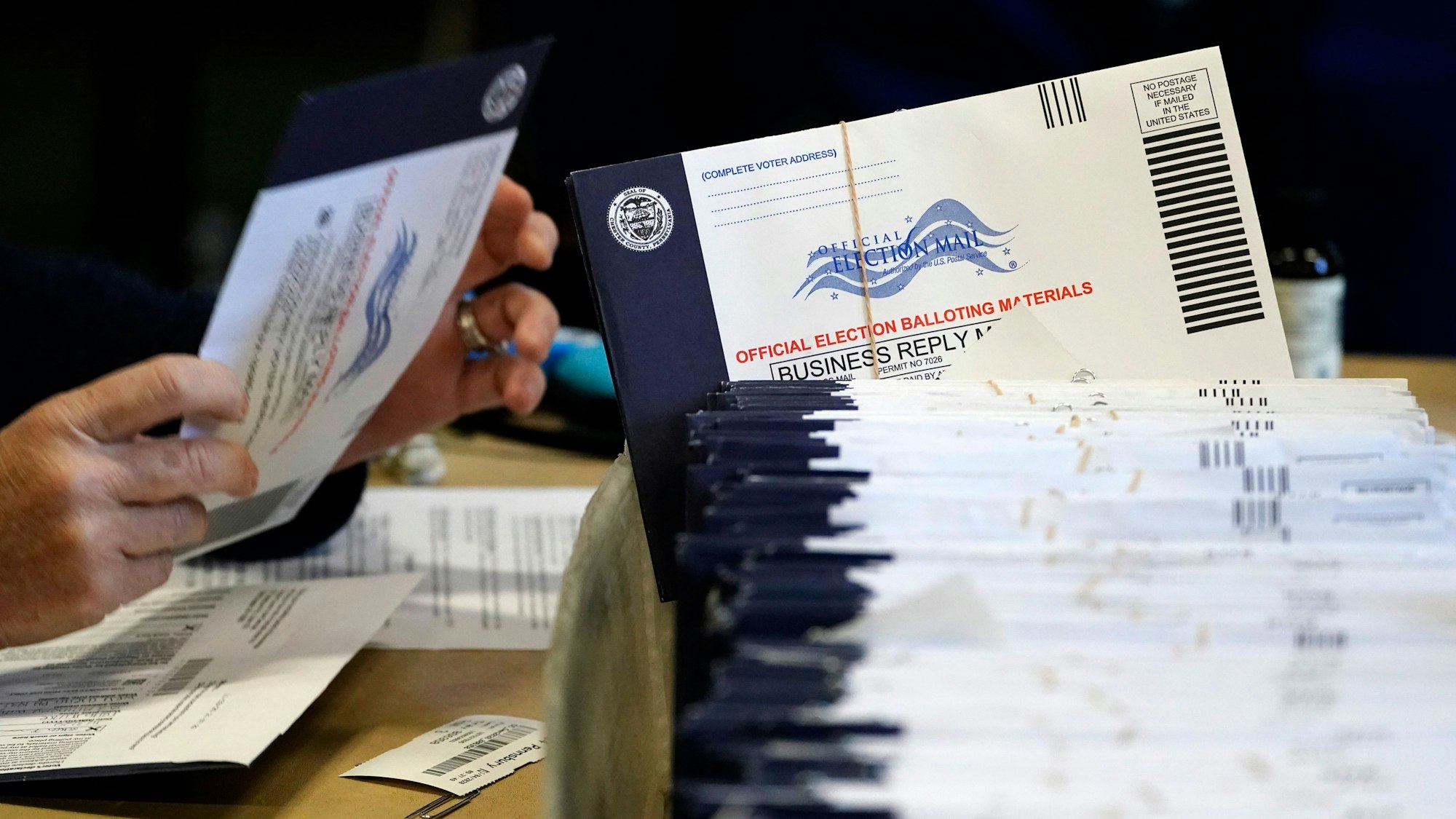 FILE - Chester County, Pa., election workers process mail-in and absentee ballots, in West Chester, Pa., Nov. 4, 2020. (AP Photo/Matt Slocum, File)