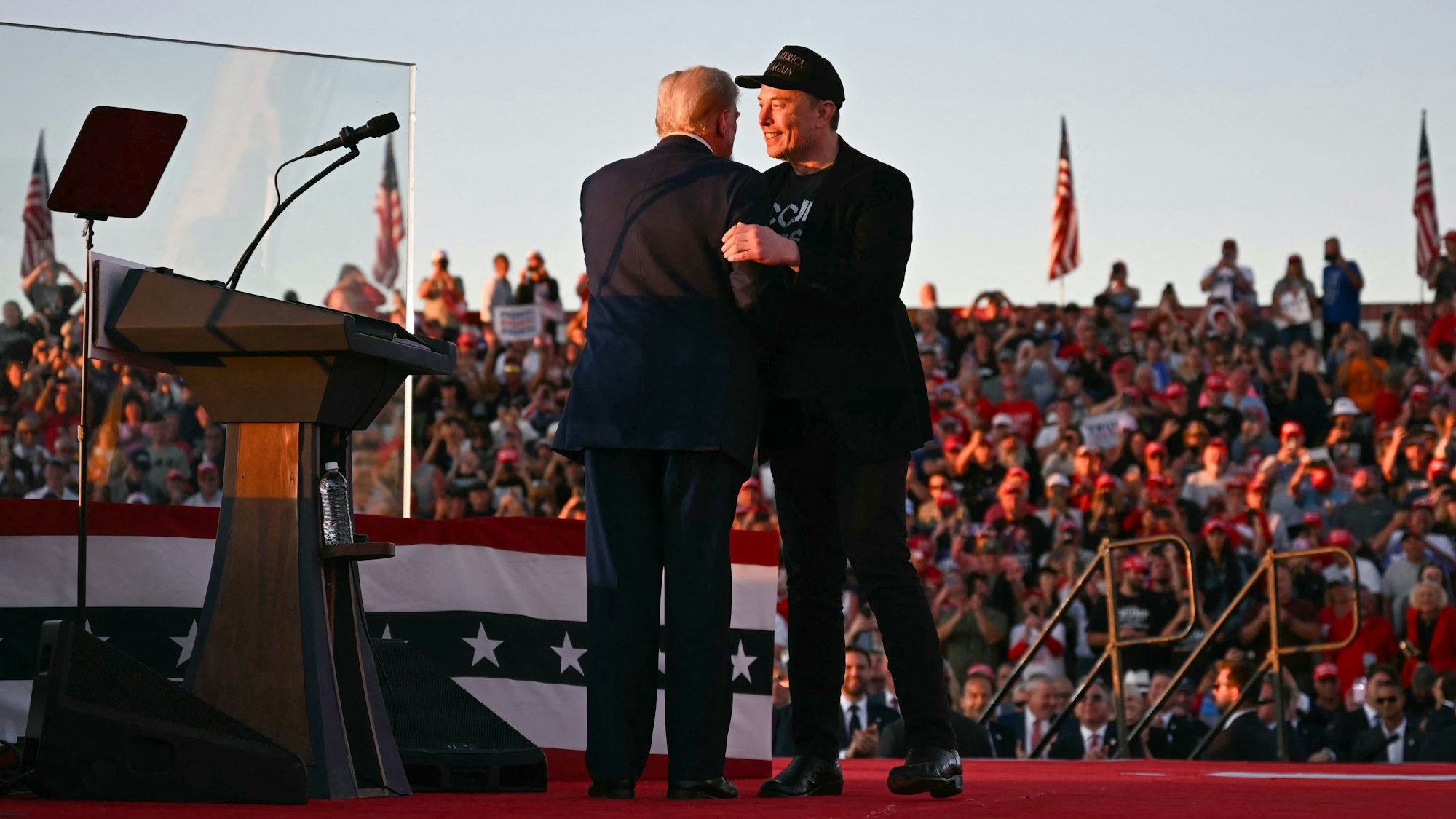 (FILES) Tesla CEO Elon Musk (R) joins former US President and Republican presidential candidate Donald Trump during a campaign rally at site of his first assassination attempt in Butler, Pennsylvania on October 5, 2024.