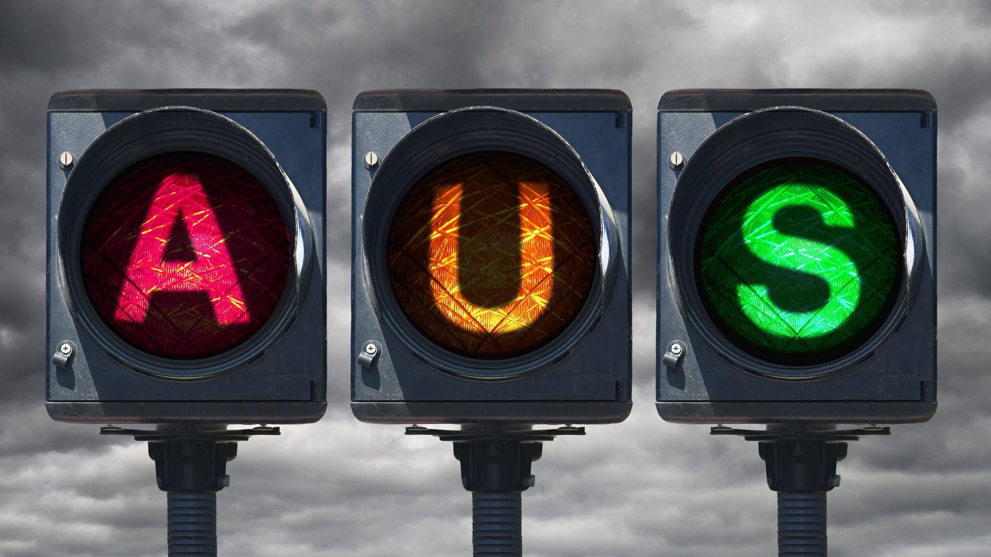 Eine Fotomontage zeigt drei Ampeln nebeneinander, die den Schriftzug „AUS“ bilden, wobei A in Rot für die SPD, U in Gelb für die FDP und S in Grün für Bündnis 90/Die Grünen steht. Den Bildhintergrund bildet ein bedrohlich dunkelgrauer Himmel.