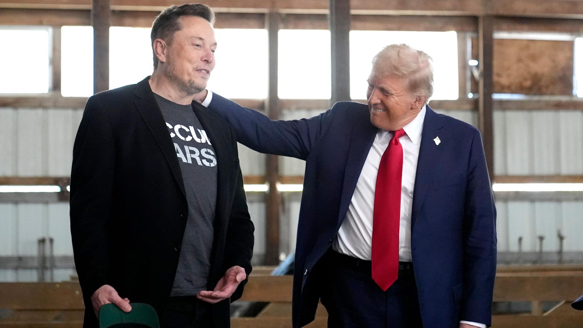 ARCHIV - 05.10.2024, USA, Butler: Elon Musk, CEO von Tesla und SpaceX, und der republikanische Präsidentschaftskandidat und ehemalige US-Präsident Donald Trump nehmen an einer Wahlkampfveranstaltung bei der Butler Farm Show teil.