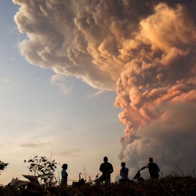 Residents watch the eruption of Mount Lewotobi Laki Laki from Lewolaga village in East Flores, East Nusa Tenggara on November 9, 2024. (Photo by ARNOLD WELIANTO / AFP)