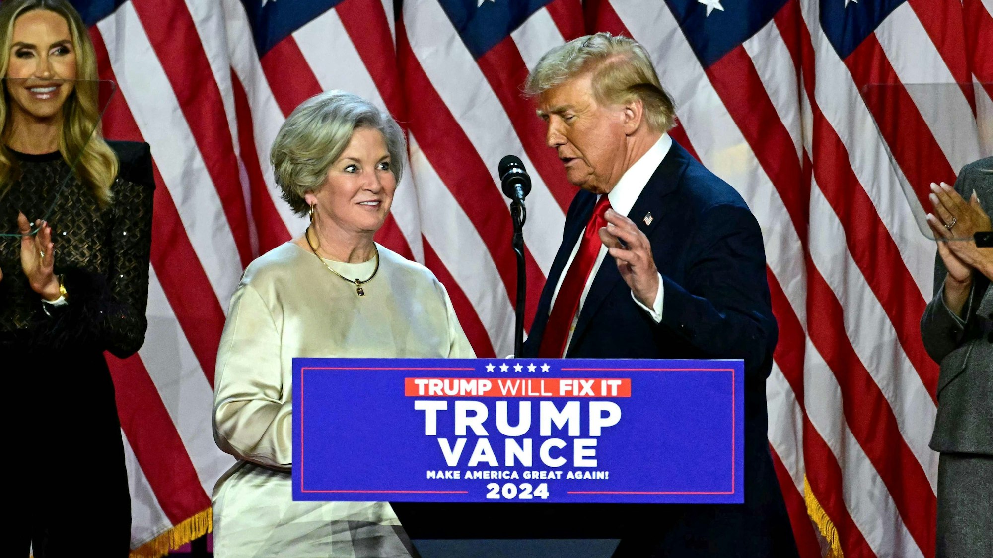 Former US President and Republican presidential candidate Donald Trump greets his campaign manager Susie Wiles (L) during an election night event at the West Palm Beach Convention Center in West Palm Beach, Florida, on November 6, 2024. Republican former president Donald Trump closed in on a new term in the White House early November 6, 2024, just needing a handful of electoral votes to defeat Democratic Vice President Kamala Harris. (Photo by Jim WATSON / AFP)