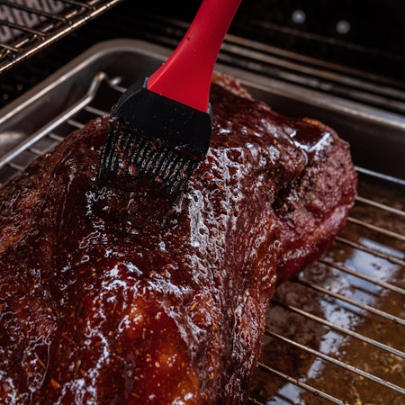Ein Schweinebraten auf einem Grill (Symbolfoto).