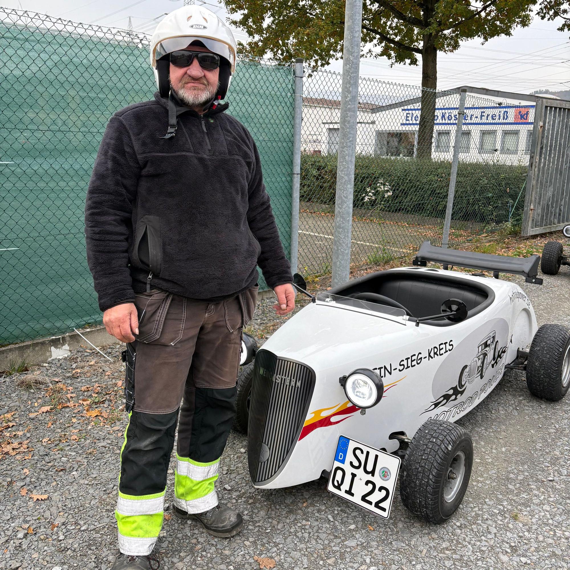 Dirk Kösling steht neben einem Mini-Hotrod.