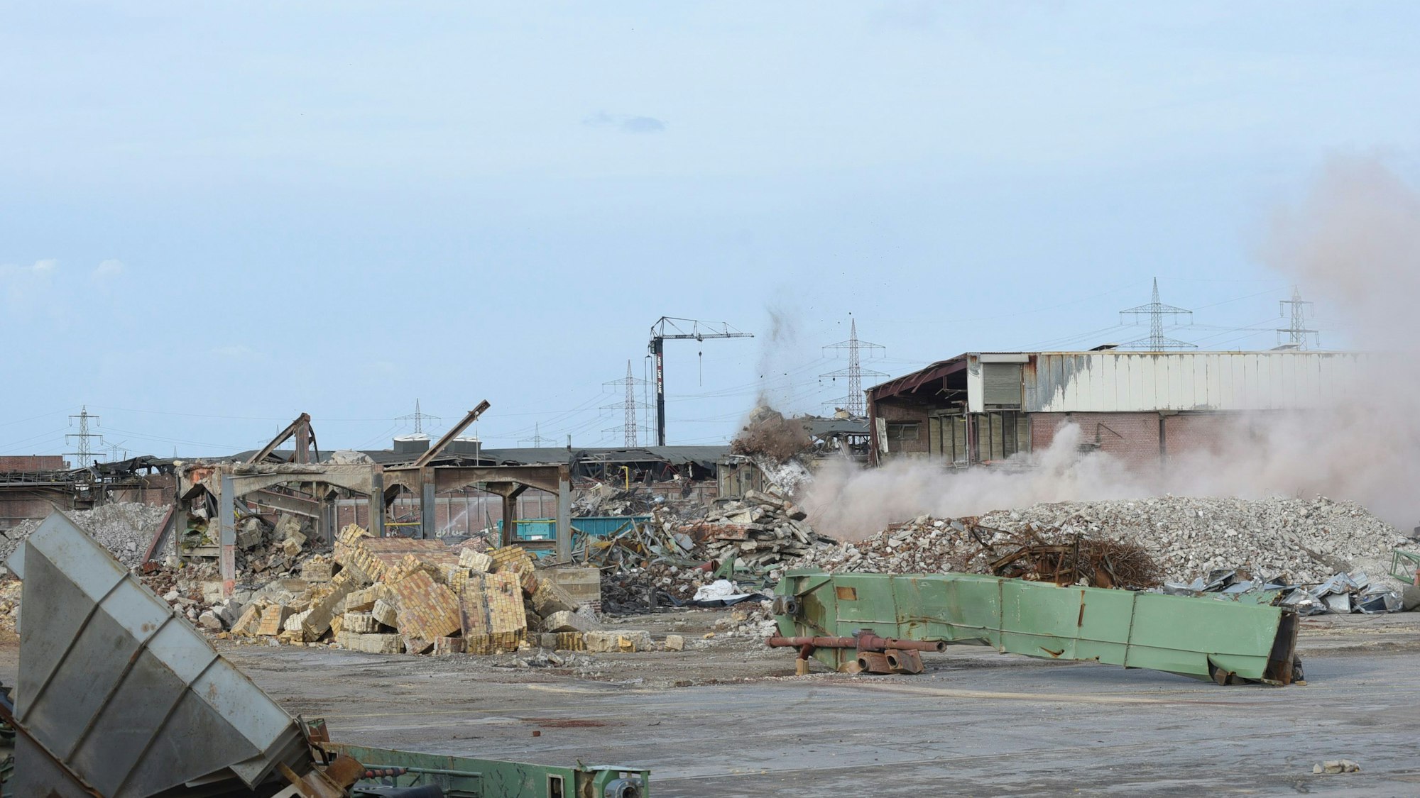 Auf dem Bild ist eine Staubwolke zu sehen. Zuvor war der letzte Schornstein gesprengt worden.