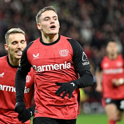 Bayer Leverkusen's German midfielder #10 Florian Wirtz (R) celebrates scoring his team's first goal with Bayer Leverkusen's Spanish defender #20 Alejandro Grimaldo during the UEFA Champions League football match Bayer 04 Leverkusen vs FC Salzburg in Leverkusen, western Germany on November 26, 2024. (Photo by INA FASSBENDER / AFP)