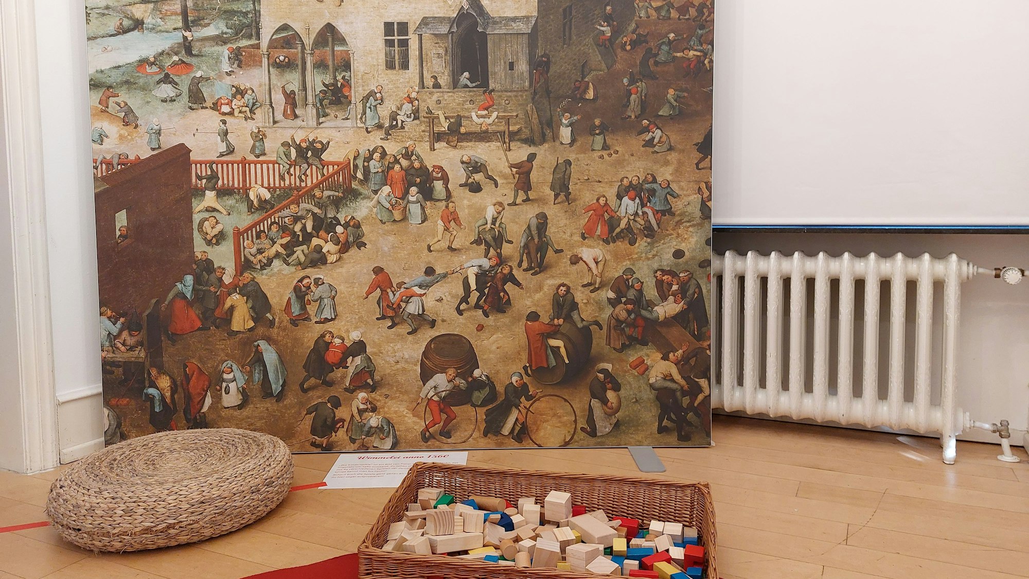 Eine Reproduktion eines Gemäldes mit spielenden Kindern.