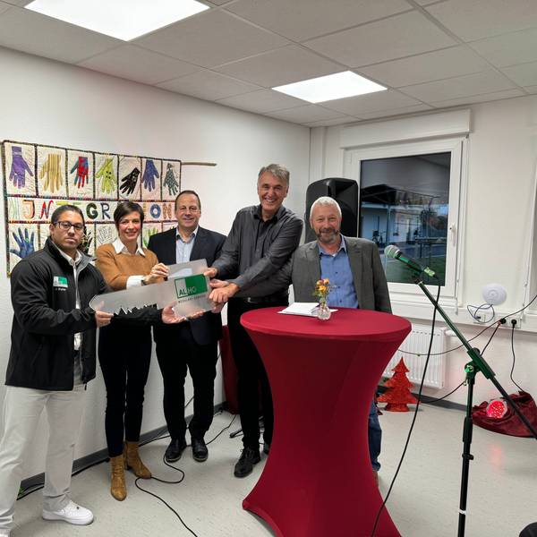 Das Foto zeigt eine Gruppe von Menschen mit einem symbolischen Schlüssel.