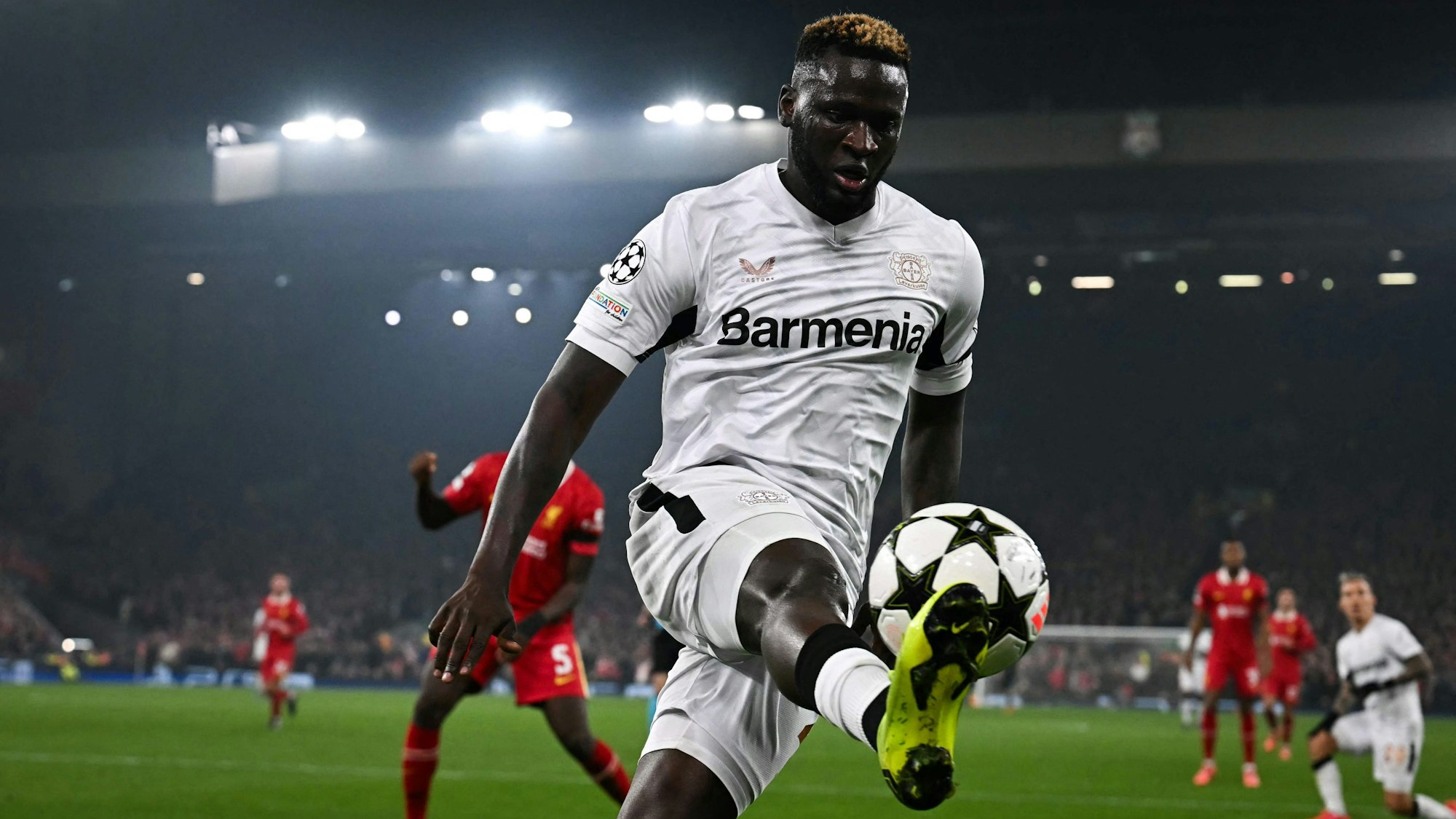 TOPSHOT - Bayer Leverkusen's Nigerian forward #22 Victor Boniface controls the ball during the UEFA Champions League football match between Liverpool and Bayer Leverkusen at Anfield stadium, in Liverpool, north west England, on November 5, 2024. (Photo by Paul ELLIS / AFP)