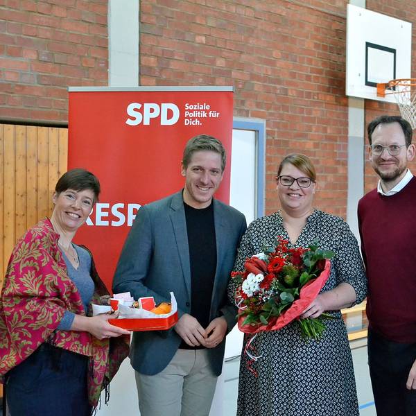 Annegret Lewak, Markus Rahmers, Andrea Kanonenberg, Thilo Waasem und Helge Herrwegen (v.l.n.r.) haben sich vor einem SPD-Roll-up zum Gruppenbild aufgestellt. Kanonenberg hält einen großen Blumenstrauß in Händen.