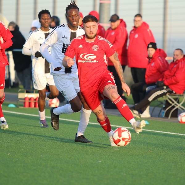 Nico Berekoven führt den Ball, ein Gegenspieler verfolgt ihn.