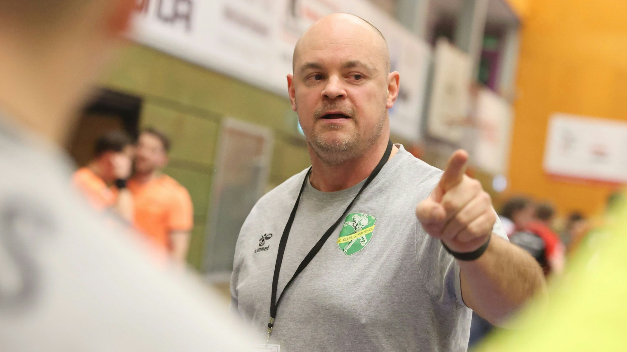 Szene einer Auszeit beim Handball, in der der Trainer etwas erklärt.