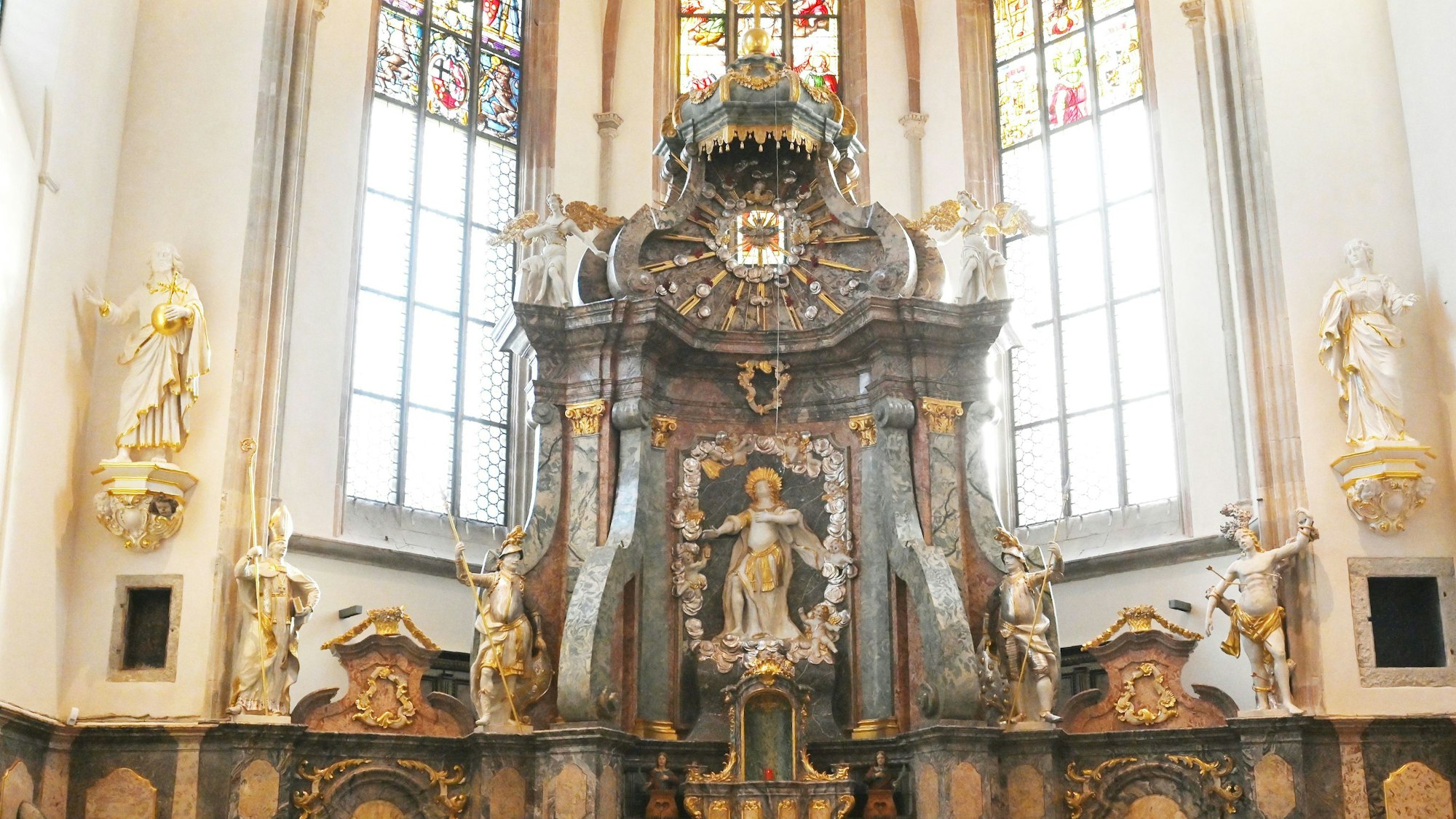 Zu sehen ist das Innere der Kirche St. Pantaleon mit kunstvollen Verzierungen und Statuen.