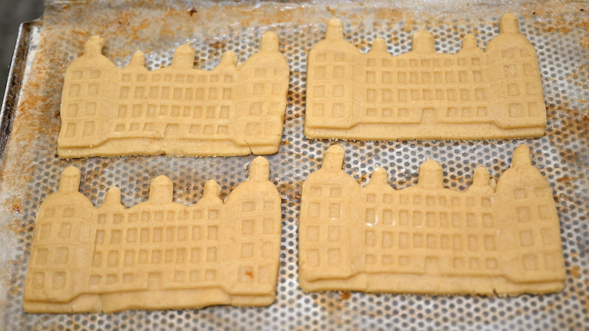 Spekulatius in der Form des Bensberger Schlosses liegen auf einem Backblech.