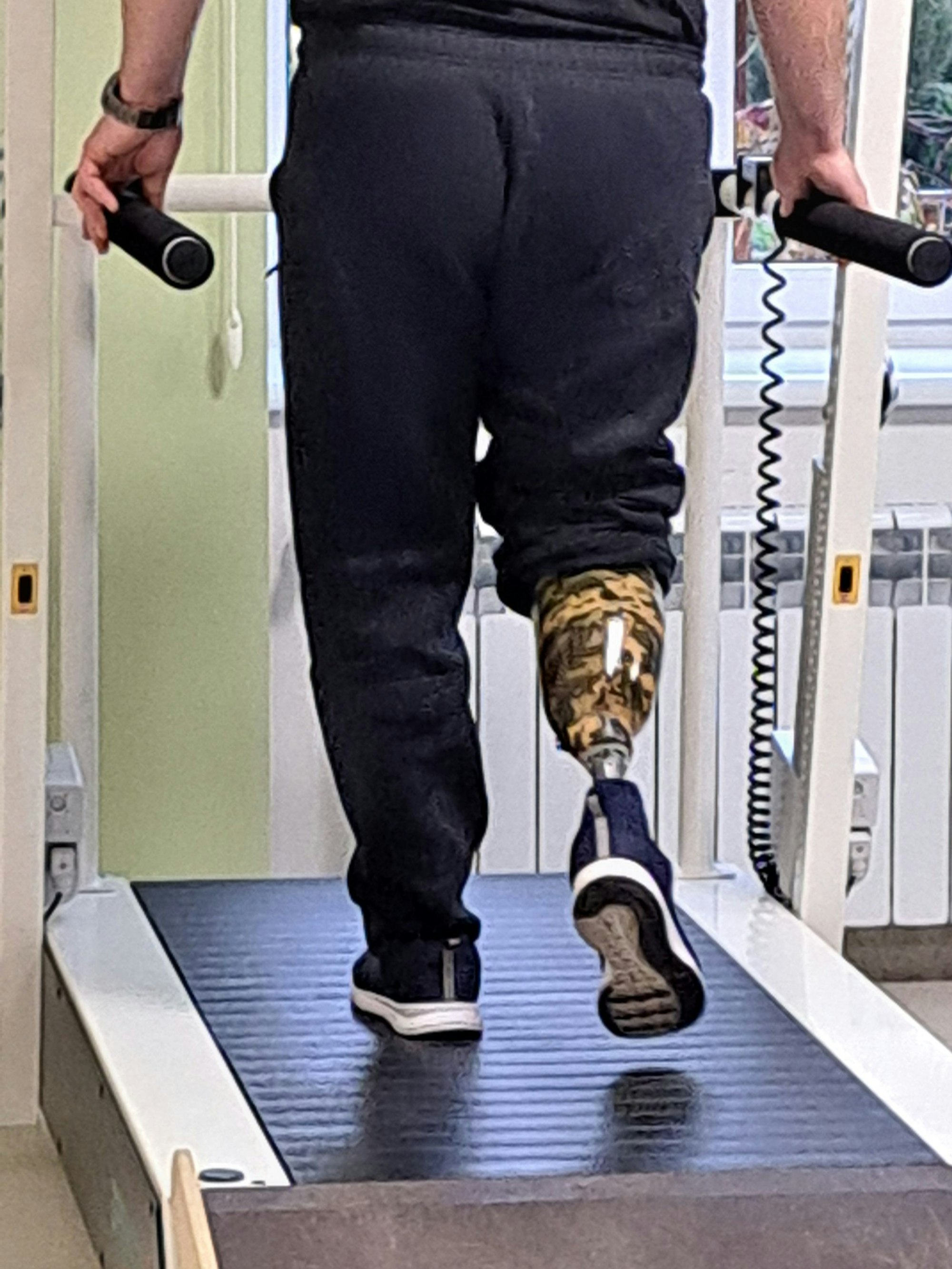 Ein ukrainischer Soldat mit einer Unterschenkelprothese geht auf einem Laufband.