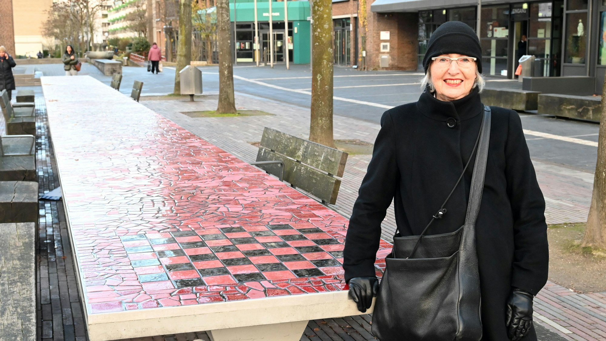 Anne Luise Müller steht vor einem langen Tisch aus Stein.