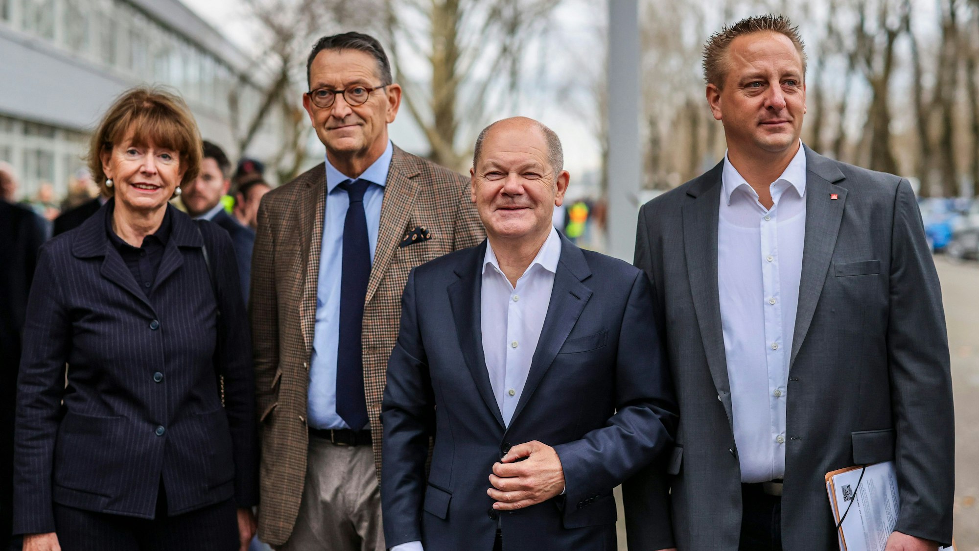 dpatopbilder - 10.12.2024, Nordrhein-Westfalen, Köln: Kölns Oberbürgermeisterin Henriette Reker (parteilos, l-r), Marcus Wassenberg, Geschäftsführer Ford Werke, Bundeskanzler Olaf Scholz (SPD) und Benjamin Gruschka, Betriebsratschef Ford Deutschland, stehen auf dem Werksgelände von Ford. Bei der Betriebsversammlung will Scholz zu den Beschäftigten sprechen, von denen viele um ihre Jobs bangen. Foto: Christoph Reichwein/dpa +++ dpa-Bildfunk +++