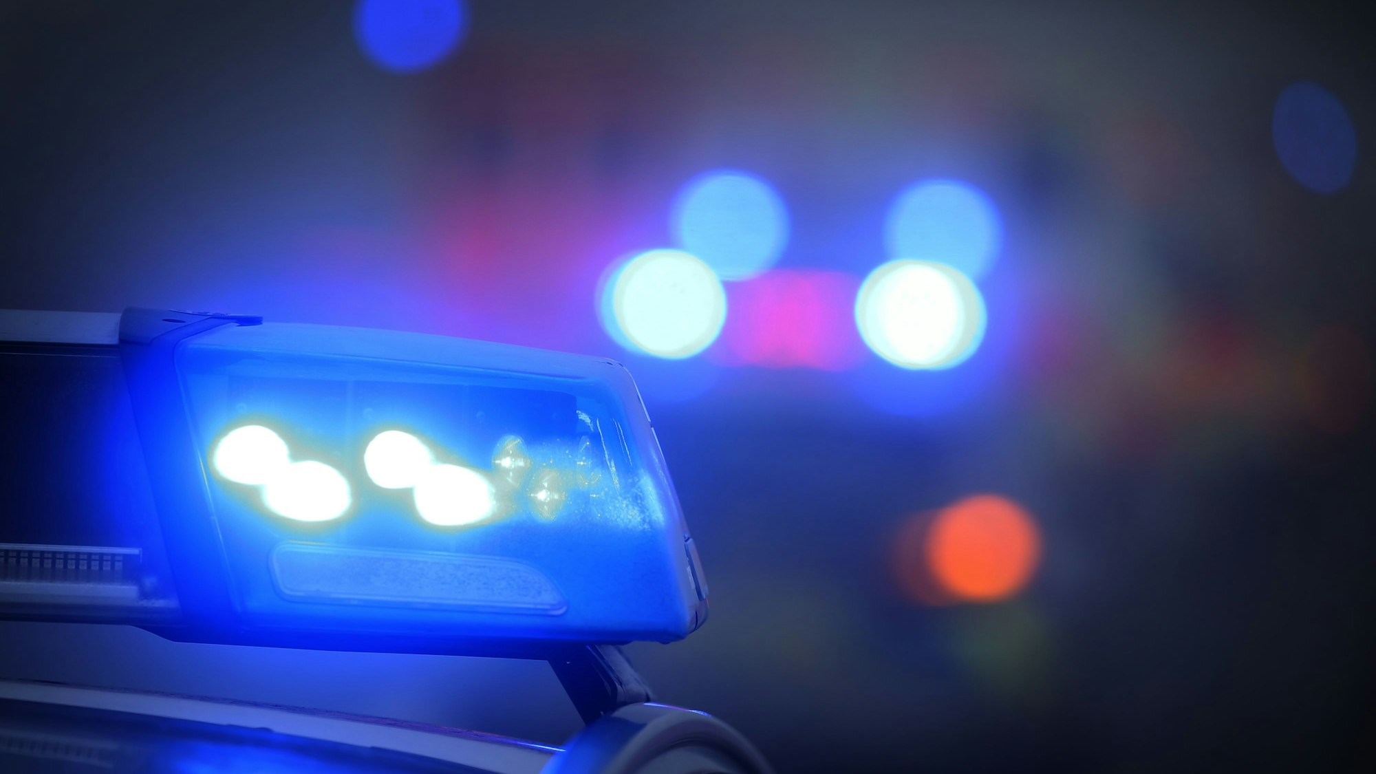 Ein Polizeiauto mit eingeschaltetem Blaulicht.