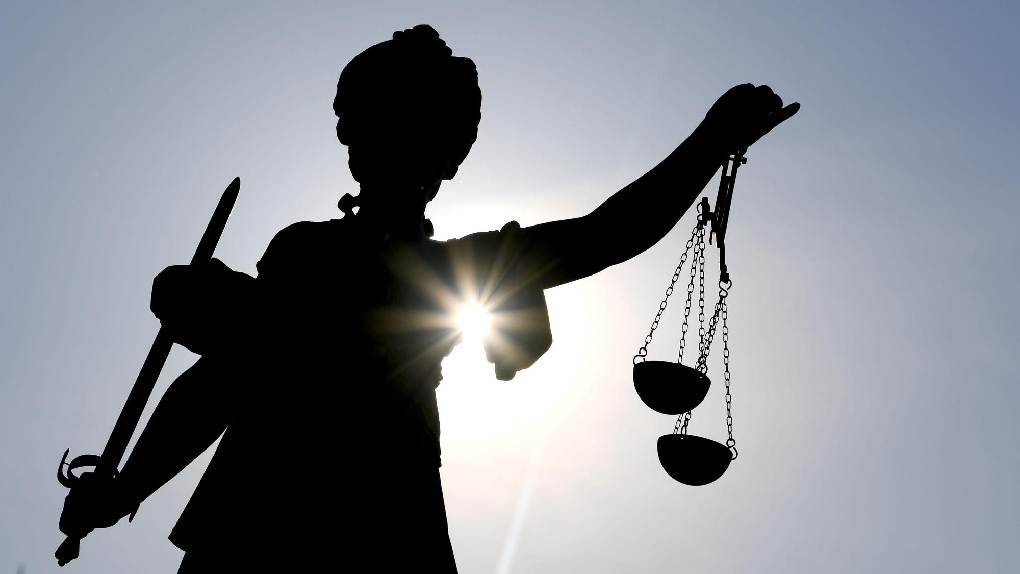 Die Statue der Göttin Justitia im Gegenlicht.