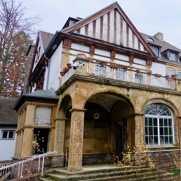 Eine historische, langsam verfallende Villa in Marienburg von außen.