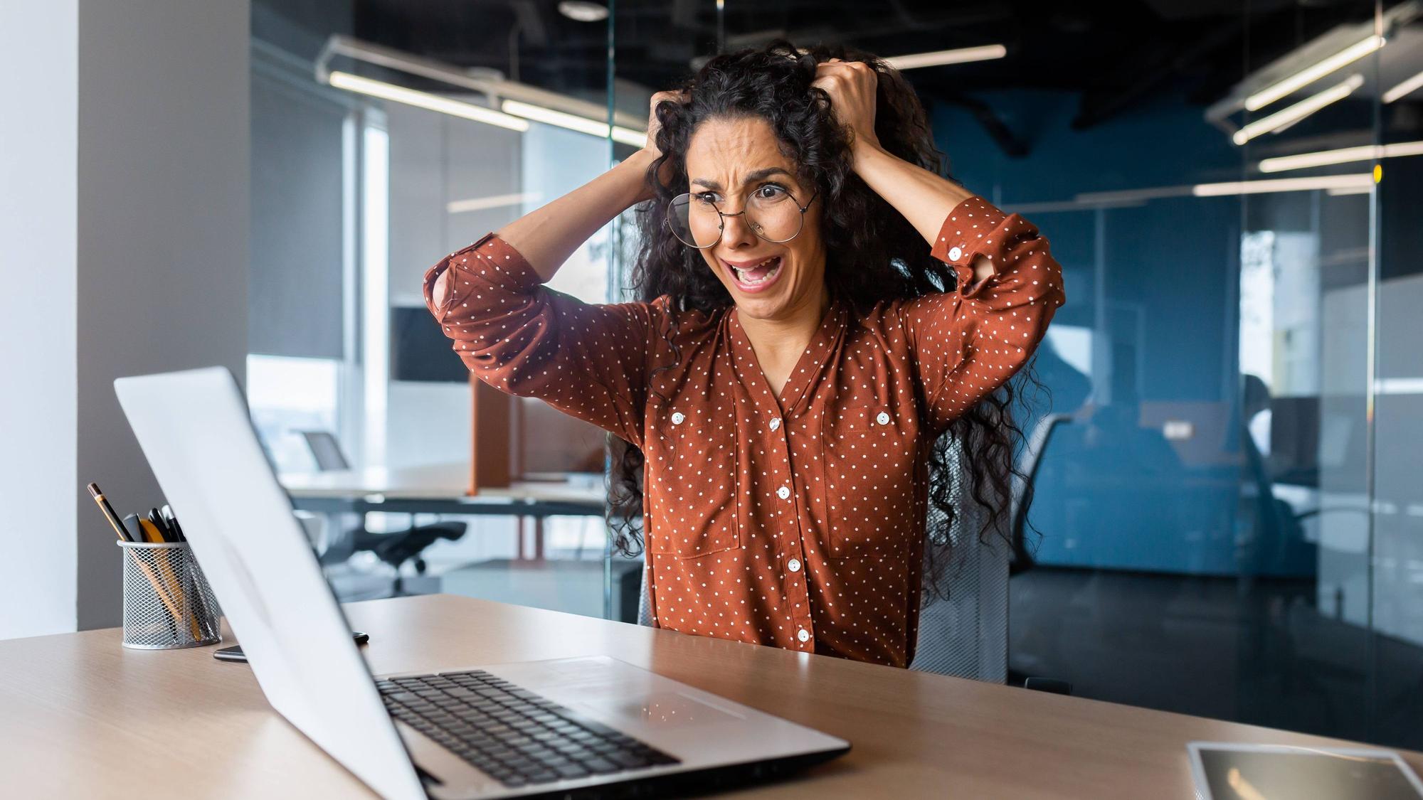 Upset woman at work yelling at laptop monitor, angry businesswoman holding hair on head inside office Upset woman at work yelling at laptop monitor, angry businesswoman holding hair on head inside office. Copyright: xVORONA RECORD DATE NOT STATED