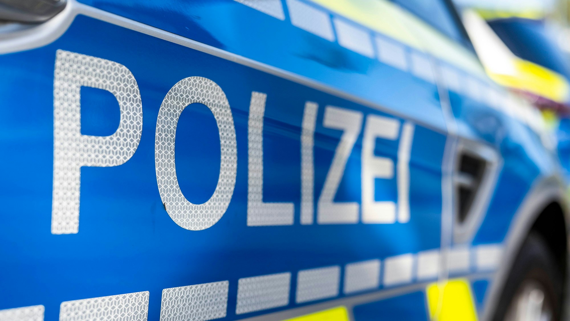 An der Tür von einem Streifenwagen steht der Schriftzug «Polizei».