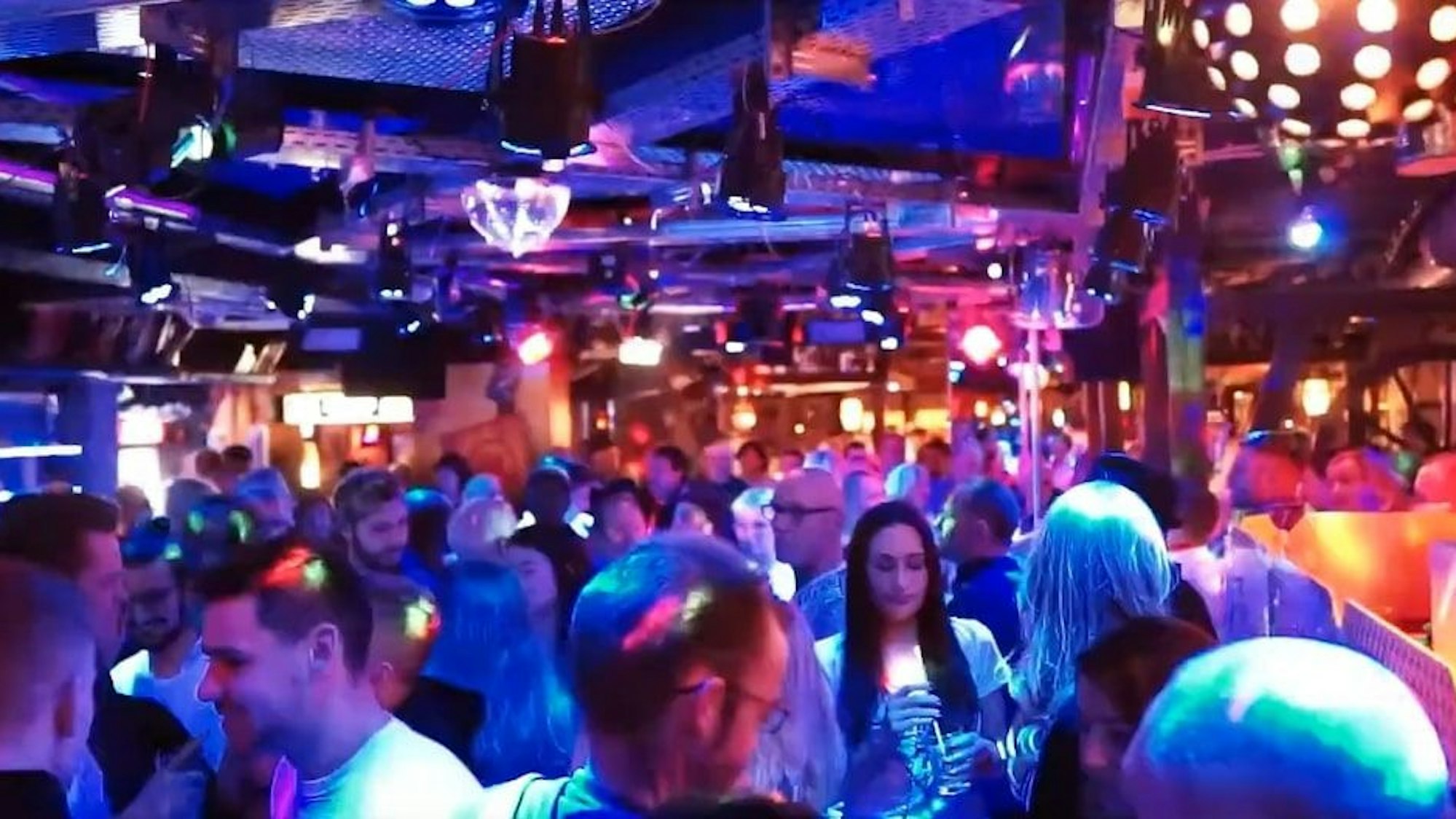 Menschen auf der Tanzfläche einer Diskothek.