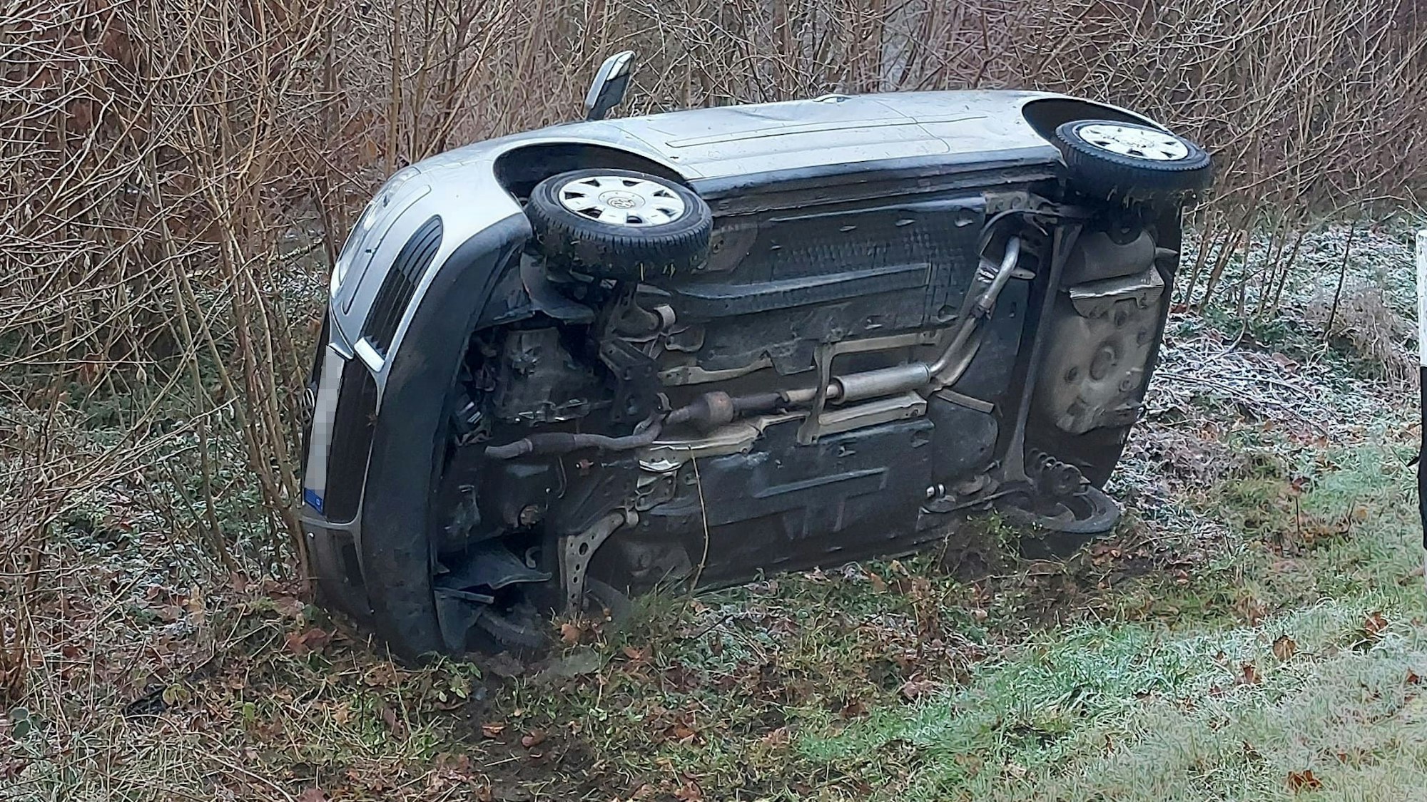 Ein Kleinwagen liegt in einem Straßengraben.