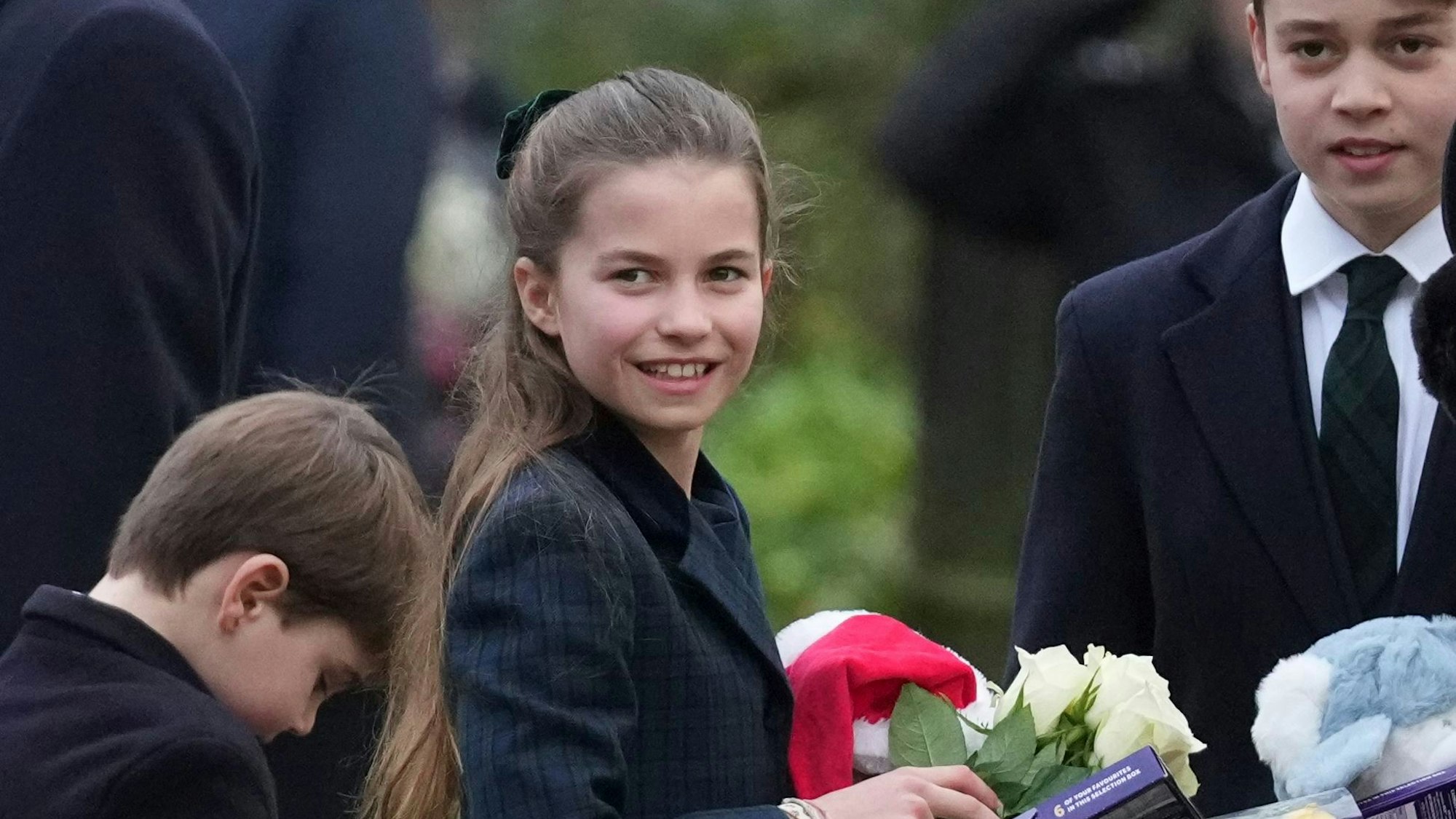 Prinz Louis, Prinzessin Charlotte und Prinz George nach dem Gottesdienst mit Geschenken von Schaulistigen.