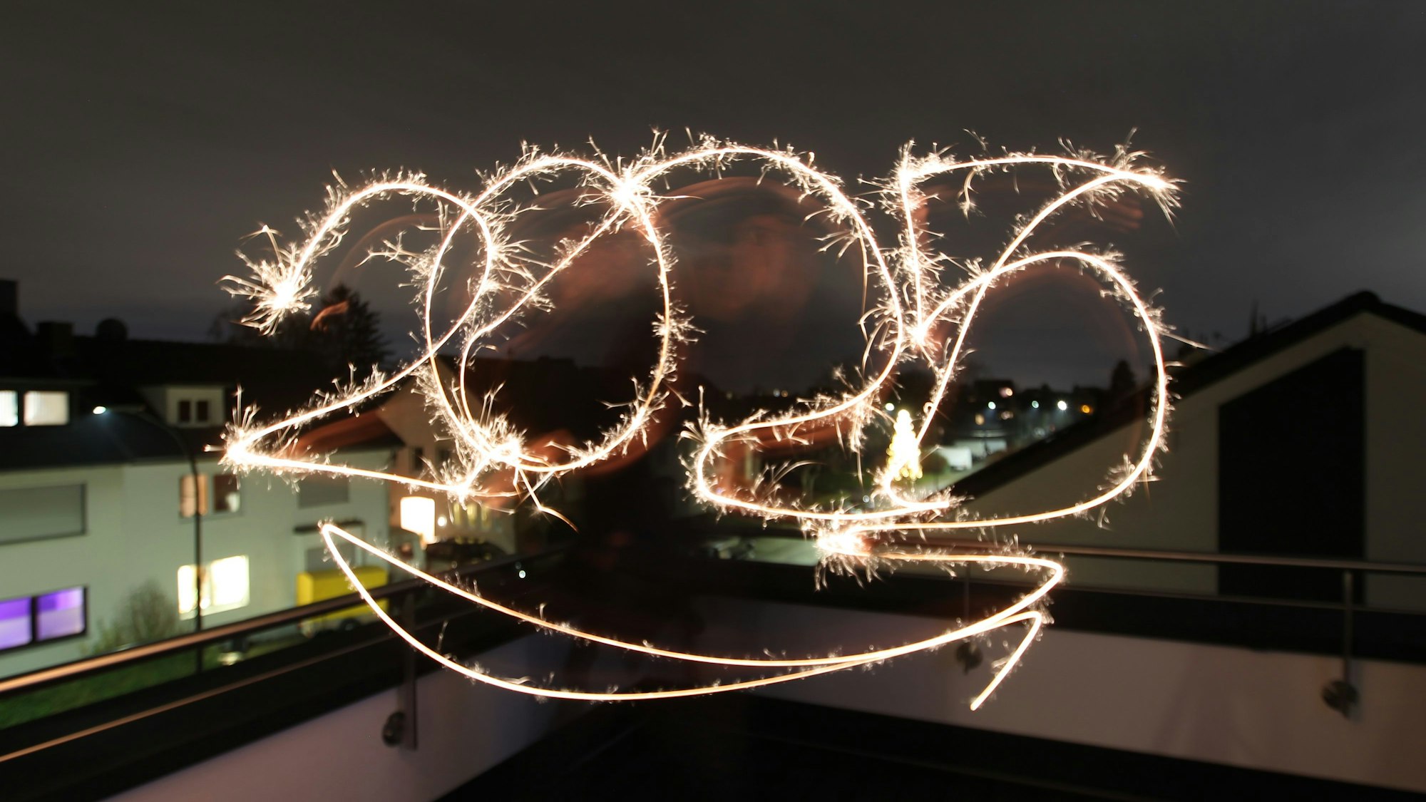 Einen Neujahrsgruß mit Wunderkerzen dank einer Langzeitbelichtung.