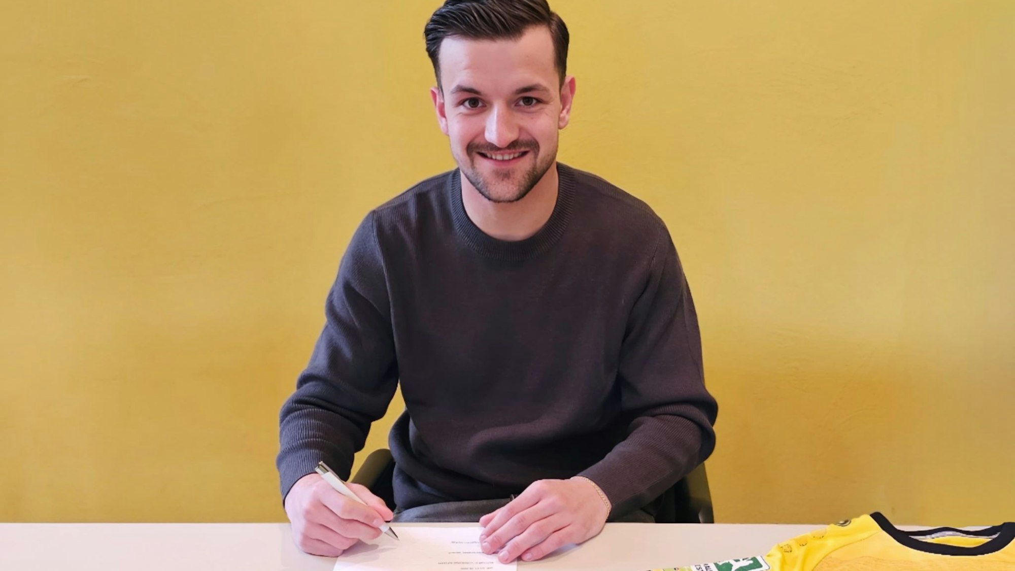 Frederic Baum bei der Unterzeichnung seines Vertrags.