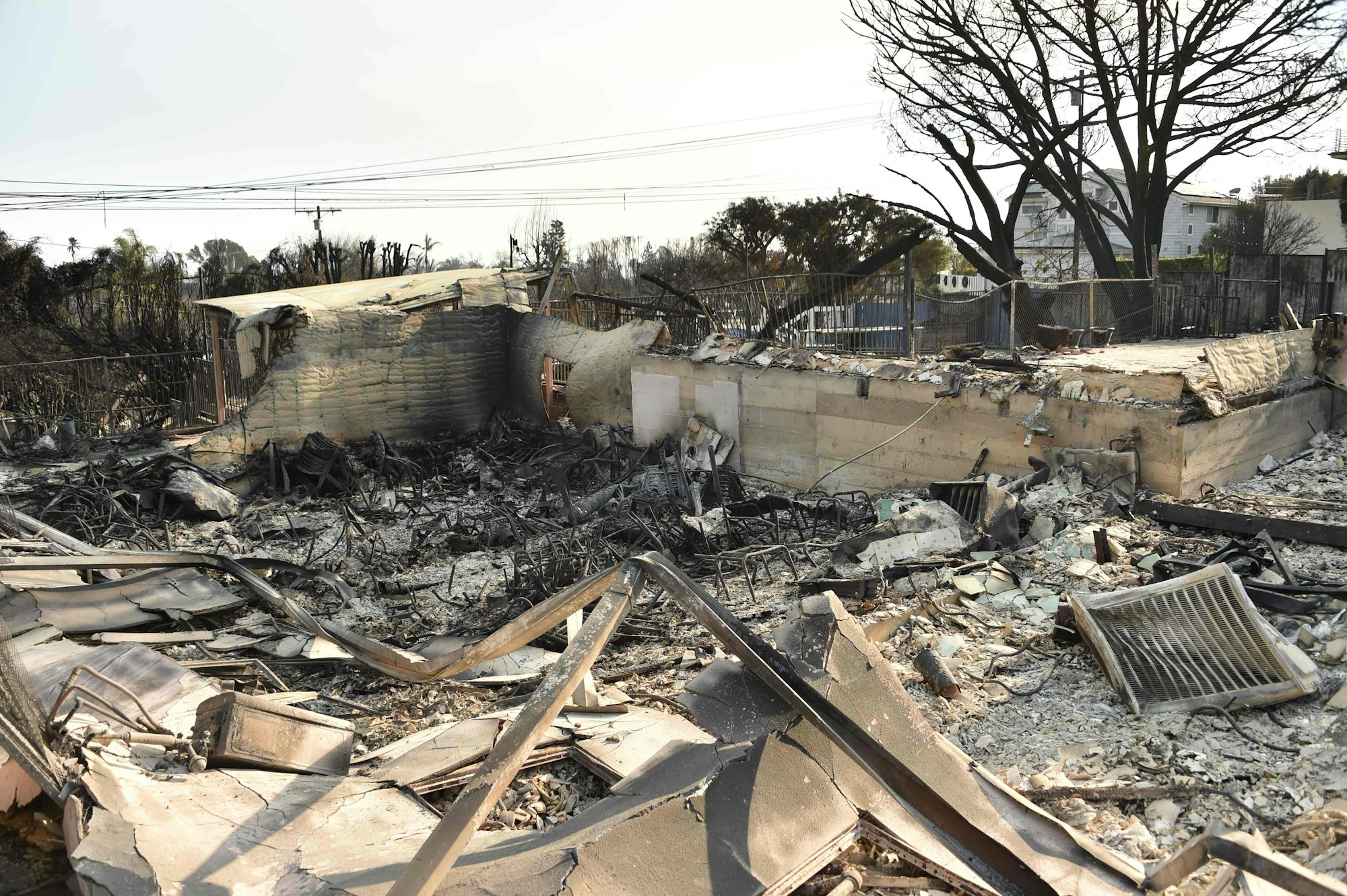 The charred remnants of the Palisades campus of international private school Le Lycee Francais de Los Angeles is seen after it was destroyed in the Palisades Fire in Pacific Palisades, California, on January 11, 2025. The Palisades Fire, the largest of the Los Angeles fires, spread toward previously untouched neighborhoods January 11, forcing new evacuations and dimming hopes that the disaster was coming under control. Across the city, at least 11 people have died as multiple fires have ripped through residential areas since January 7, razing thousands of homes in destruction that US President Joe Biden likened to a "war scene." (Photo by Chris DELMAS / AFP)